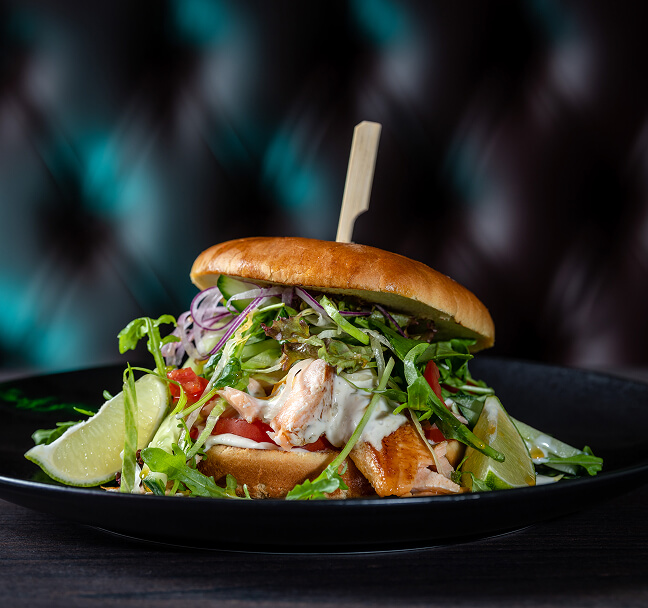 Leckerer Burrger mit Hähnchen, Salat und Toppings